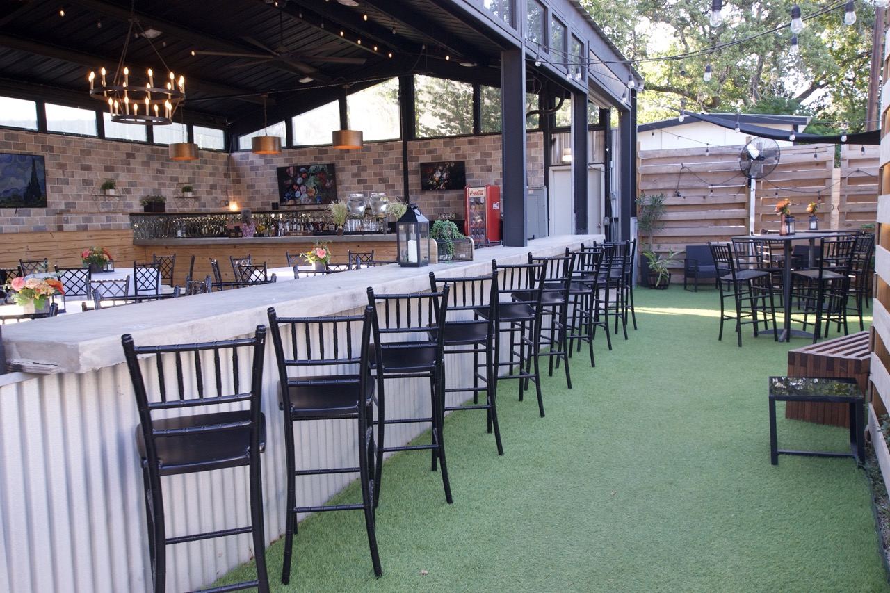 The covered private bar at Screaming Goat with bar seating along the rail, open for a standing event
